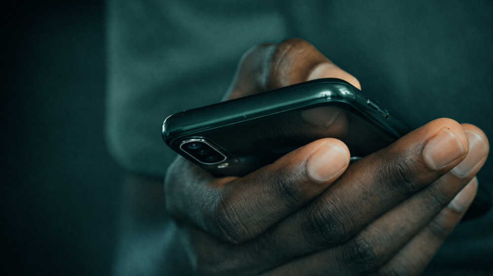 Close-up of a person holding a smartphone in one hand